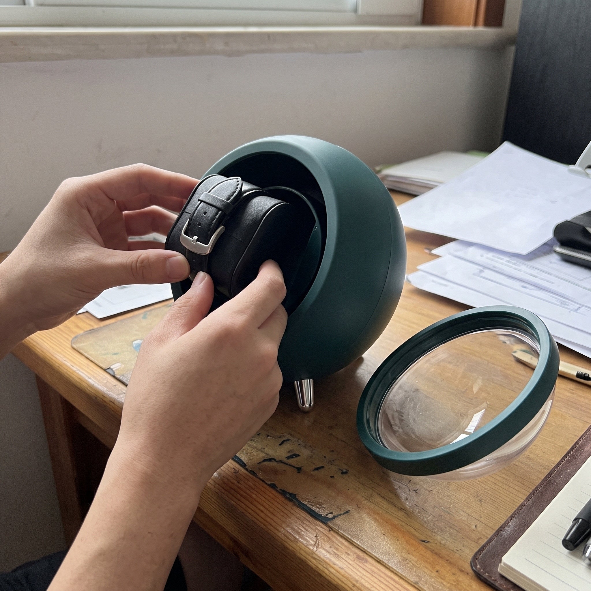 Hands seating a watch cushion in the Green winder