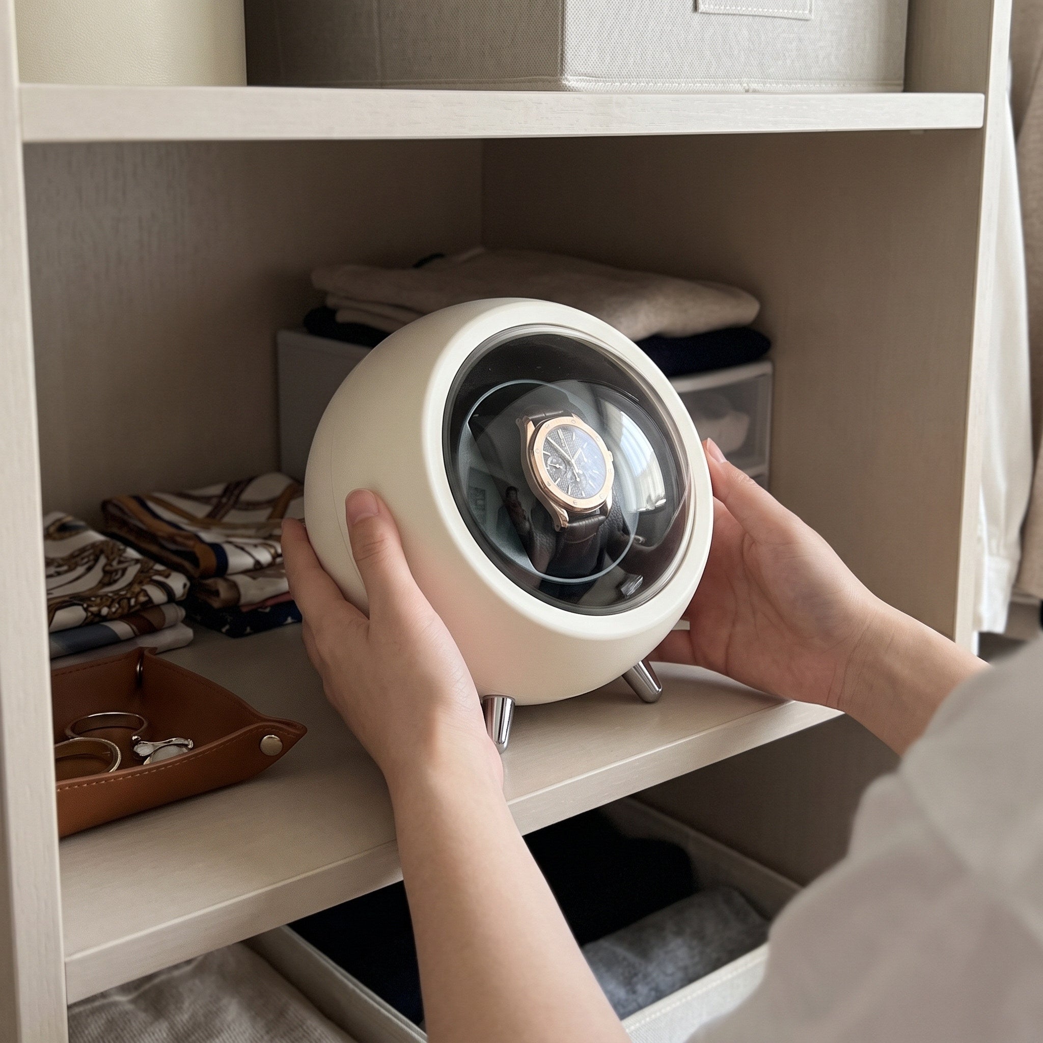 Hands placing an Cream winder on a closet shelf