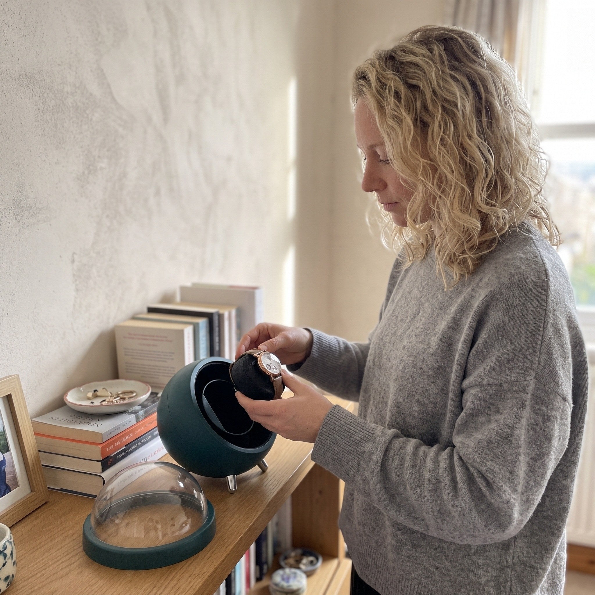 Chloe lifting her watch cushion from a Green winder